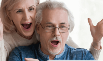 Old couple looking excitedly at their energy bill.