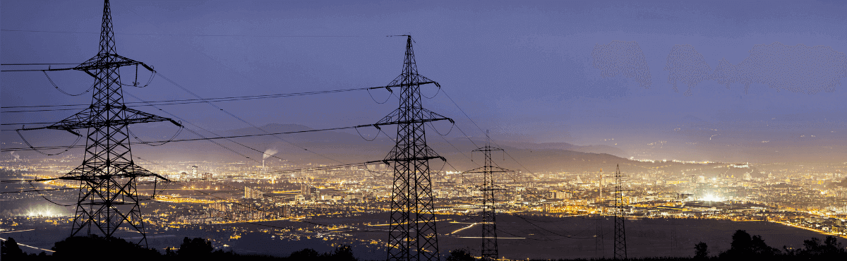 Power grid in the early evening, with city lights in the background.