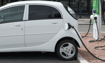 White electric vehicle at charging station