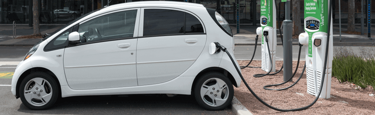 White electric vehicle at charging station