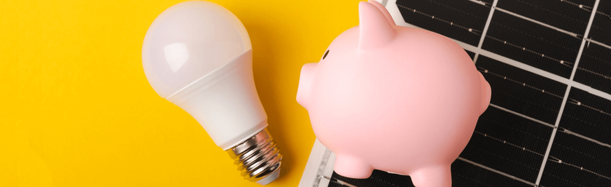 Piggy bank, light bulb and solar panel flat lay