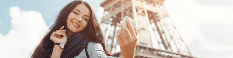 Woman taking selfie infront of Eiffel tower