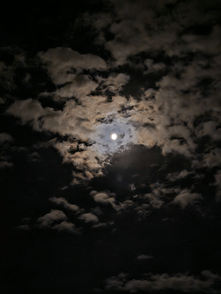 Moon in cloudy night sky