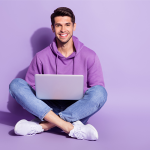 Man with laptop against purple background