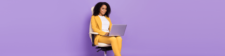 Woman looking at laptop against purple background