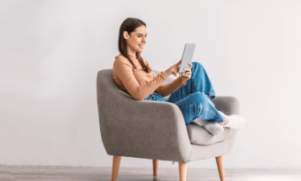 Happy woman using a tablet at home