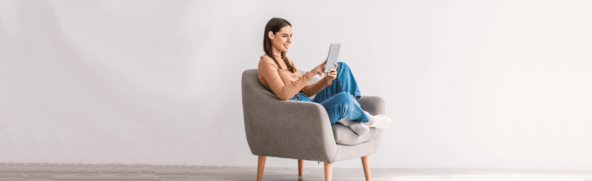 Happy woman using a tablet at home