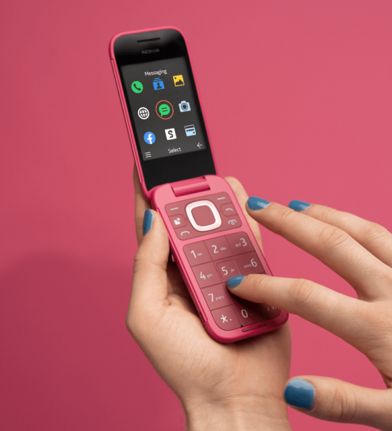 Pink Nokia flip phone being used
