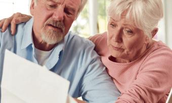 Older couple looking at their energy bill with concern.