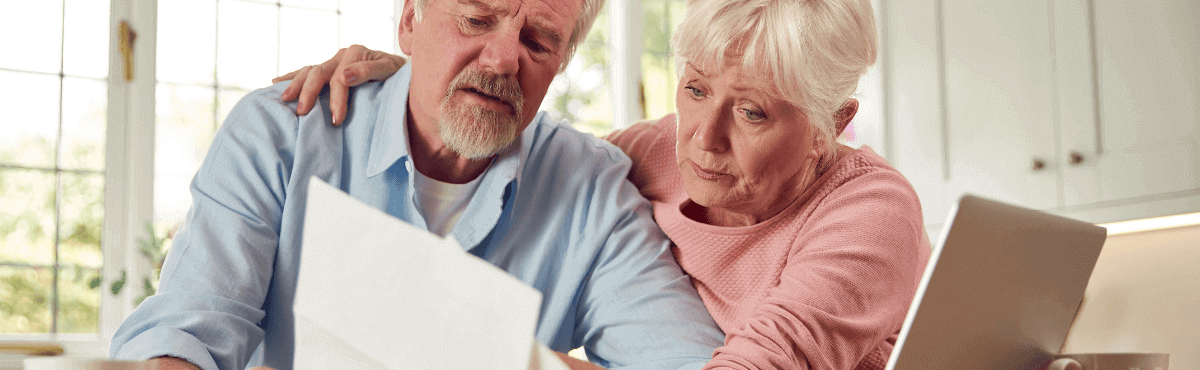 Older couple looking at their energy bill with concern.