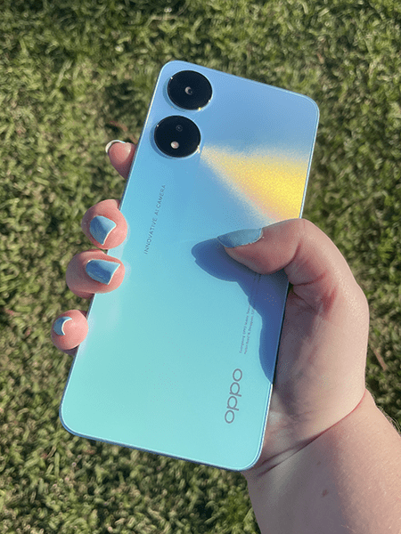 Person holding OPPO A78 5G phone in blue
