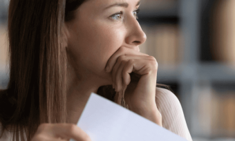 Woman looking anxious at her energy bill