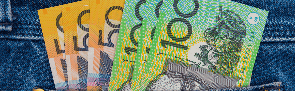 Australian money sitting in jean pocket.