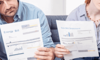 Man and woman looking anxiously at their energy bills.