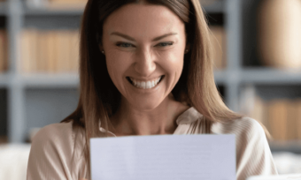 Woman looking ecstatic at her energy bill.