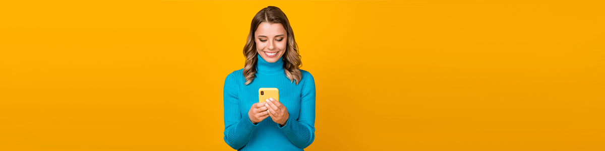 Switch to a cheaper phone plan article image with woman holding phone against yellow background
