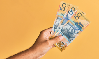 Hand holding Australian $50 notes