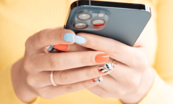 Close-up of woman's hands holding grey iPhone