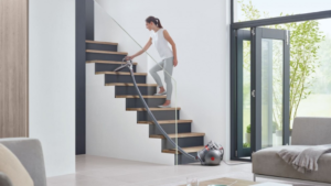 woman vacuuming stairs with Dyson big ball vacuum