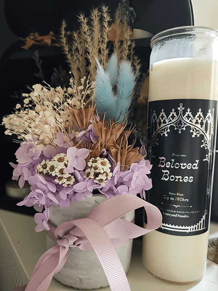 Photo of flowers and candle indoors