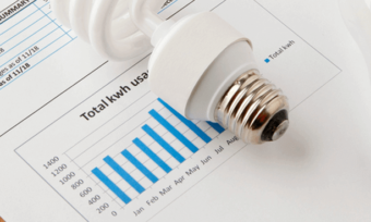 Light bulbs sitting on top of energy bill