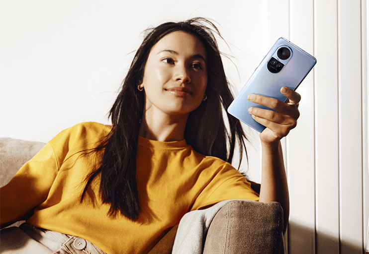 Woman in yellow shirt using OPPO phone at home 