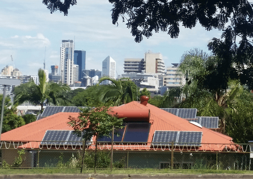 Solar panels on roof with city skyline