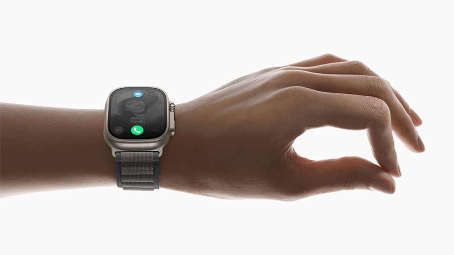 Hand wearing Apple Watch Ultra and demonstrating double tap gesture