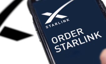 Hand using mobile phone to order Starlink internet