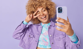 Happy woman using purple phone