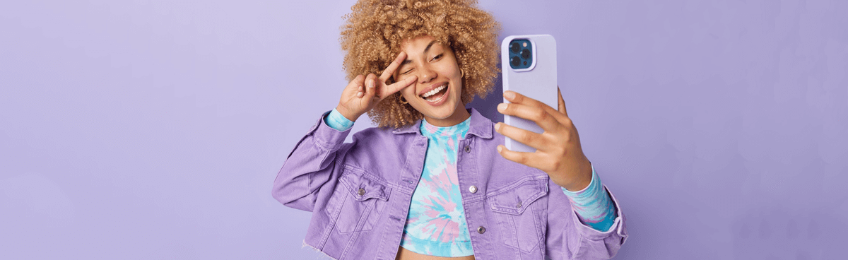 Happy woman using purple phone