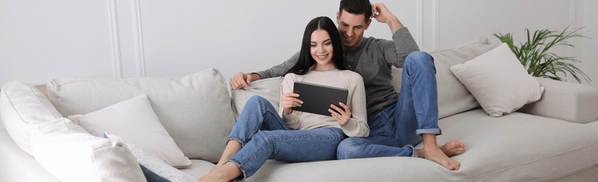 Young couple watching laptop together at home