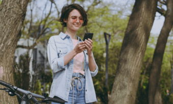 Young woman using phone in park