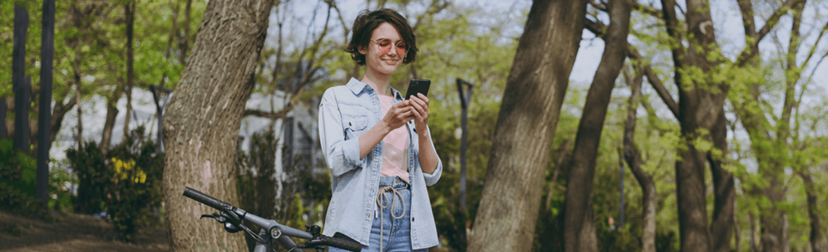 Young woman using phone in park