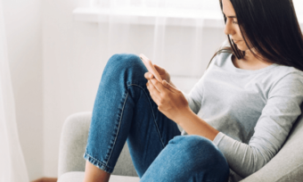 Young woman using phone at home