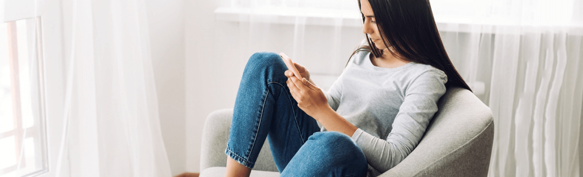 Young woman using phone at home