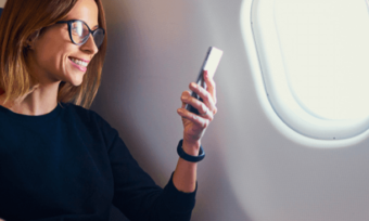 Woman using a smartphone on a plane