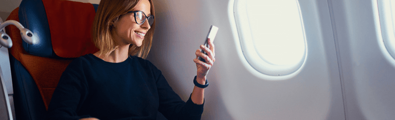 Woman using a smartphone on a plane