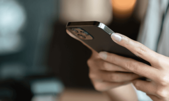 Woman's hands using black iPhone