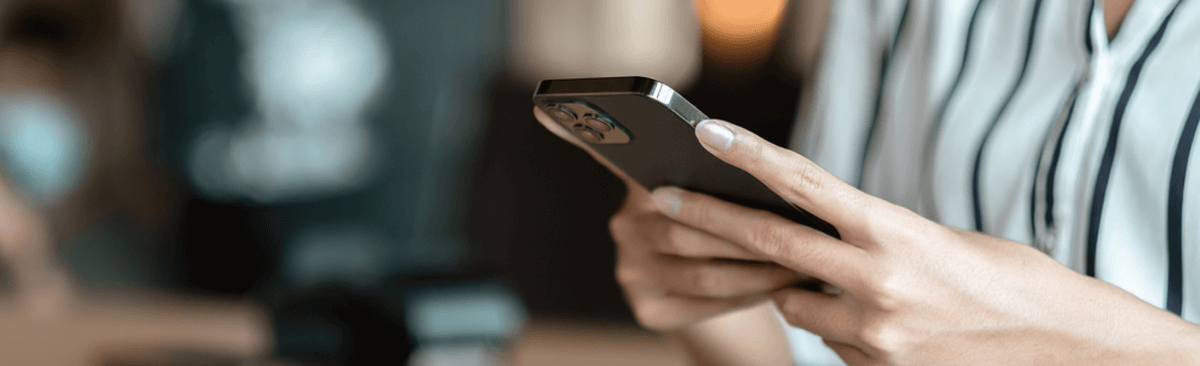 Woman's hands using black iPhone