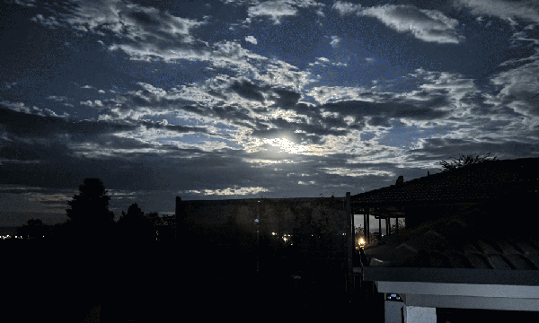 The cloudy sky and moon at night.