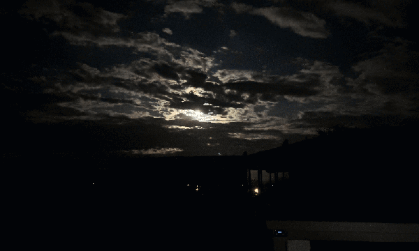 The cloudy sky and moon at night.