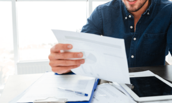 Man reading power bill in kitchen