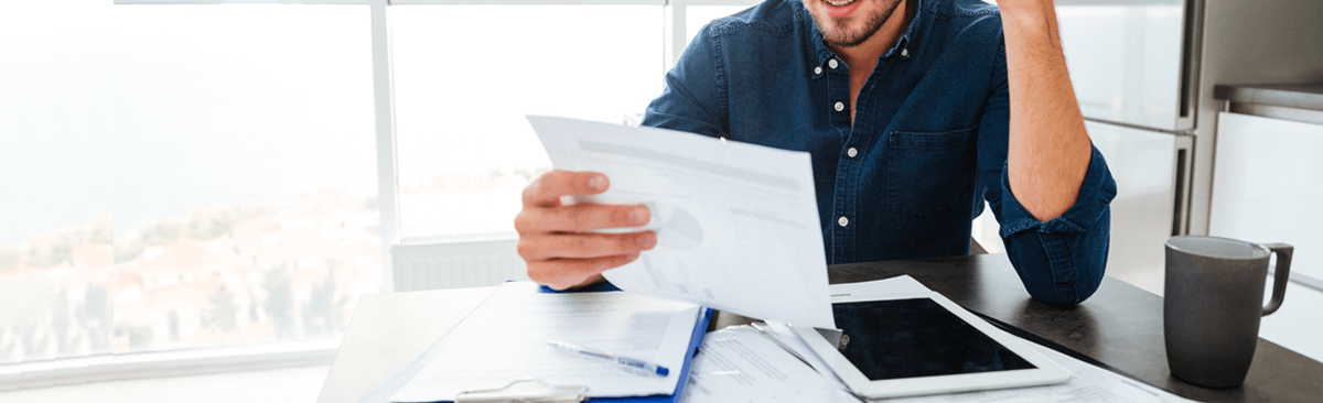 Man reading power bill in kitchen