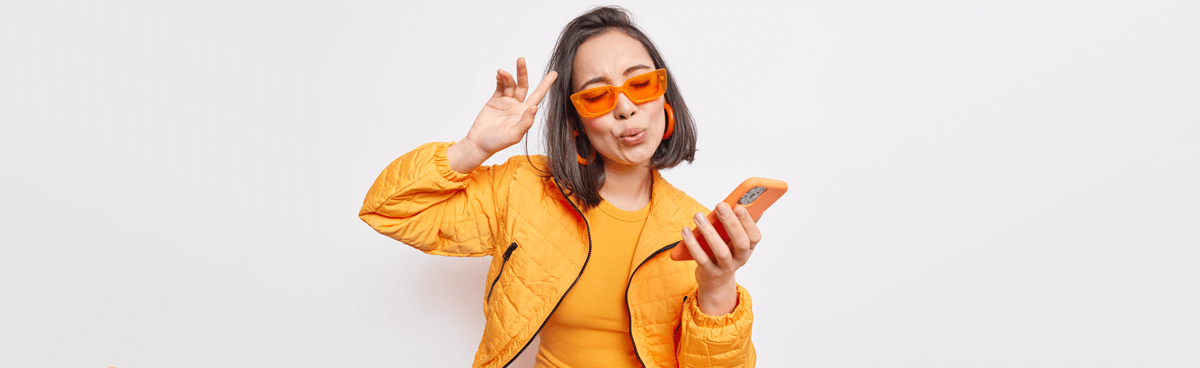 Amaysim sale - young woman using orange phone wearing orange outfit