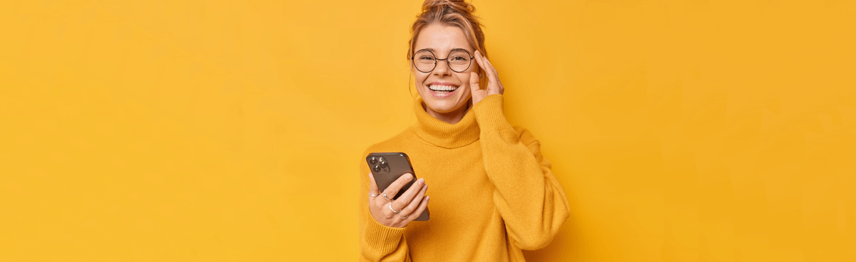 Happy woman with 4G phone and yellow background