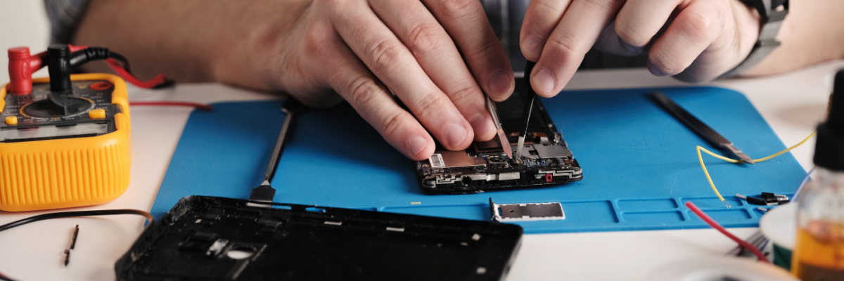 Technician refurbishing phone