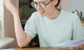 Confused person reading expensive bill