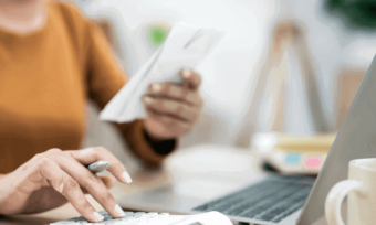 Woman reading bill with calculator