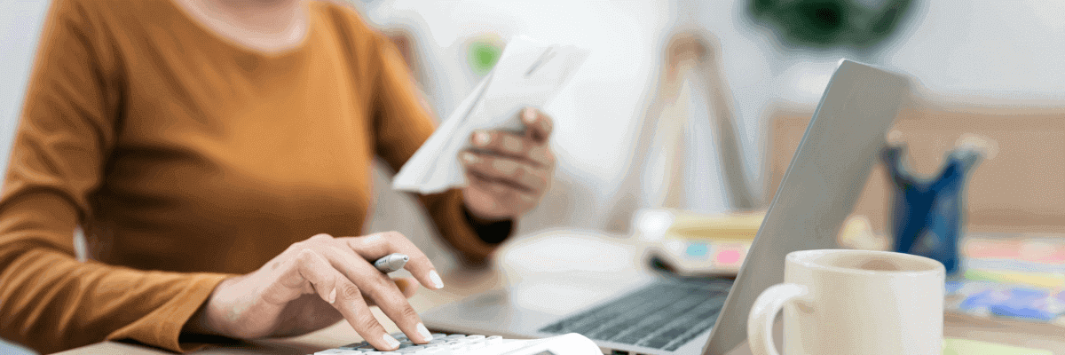 Woman reading bill with calculator